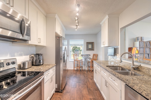 kitchen featuring white cabinetry, sink, and appliances with stainless steel finishes