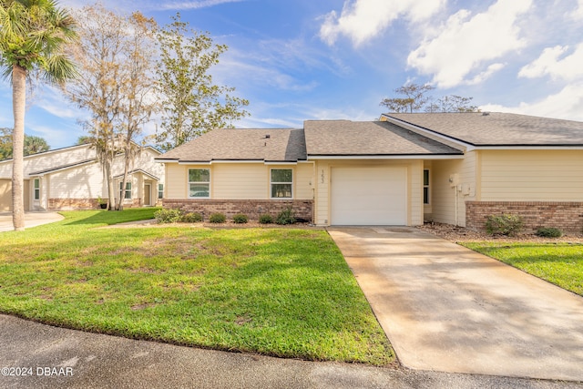 view of front of house featuring a garage and a front lawn