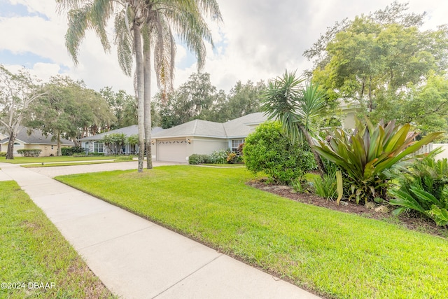 view of front of property with a front lawn and a garage