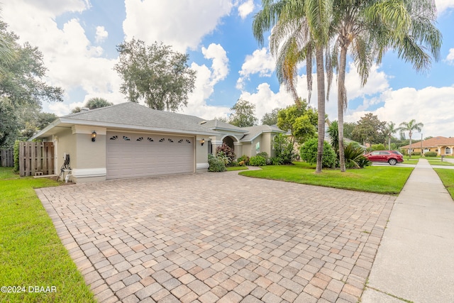 ranch-style home with a garage and a front lawn