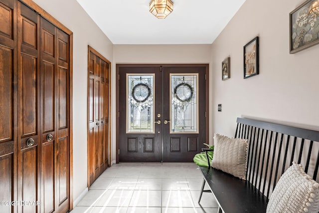 foyer featuring light tile patterned floors and french doors