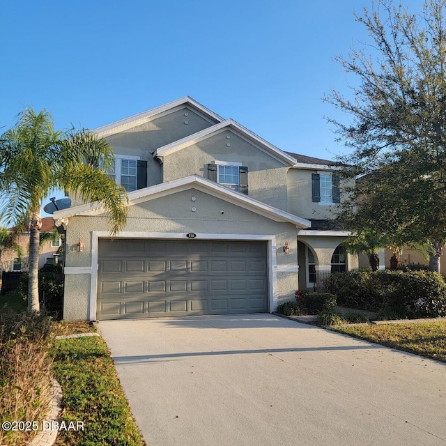 traditional-style house with stucco siding and concrete driveway