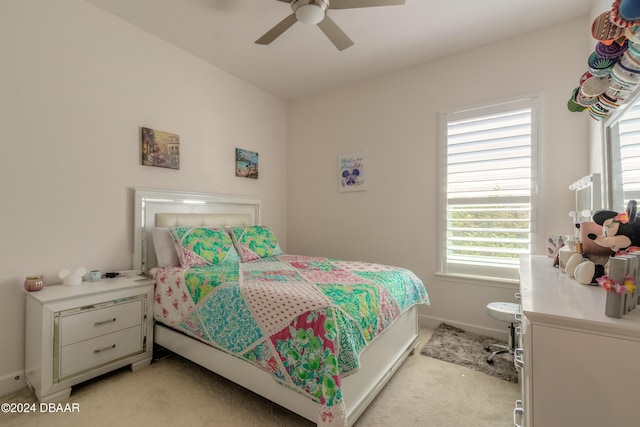 bedroom with light carpet, multiple windows, and ceiling fan