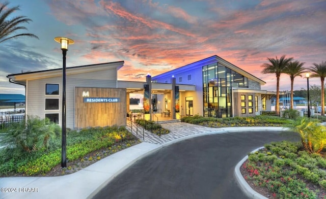 view of outdoor building at dusk