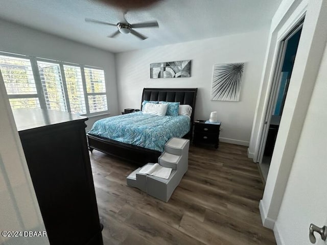 bedroom featuring dark hardwood / wood-style flooring and ceiling fan