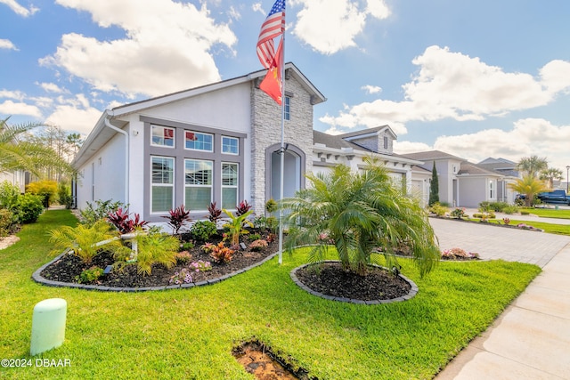 view of front of property with a garage and a front lawn