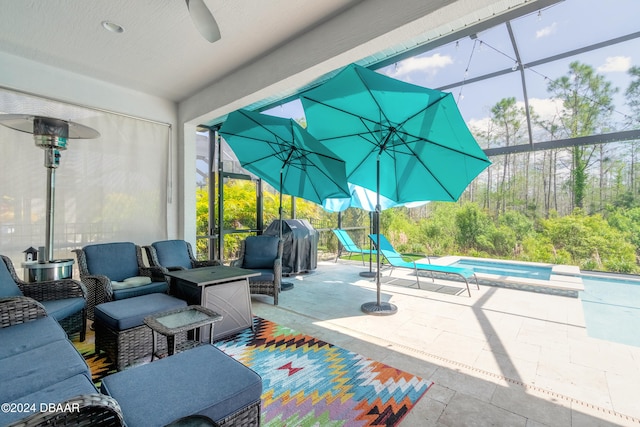 view of patio featuring a pool with hot tub, glass enclosure, and ceiling fan