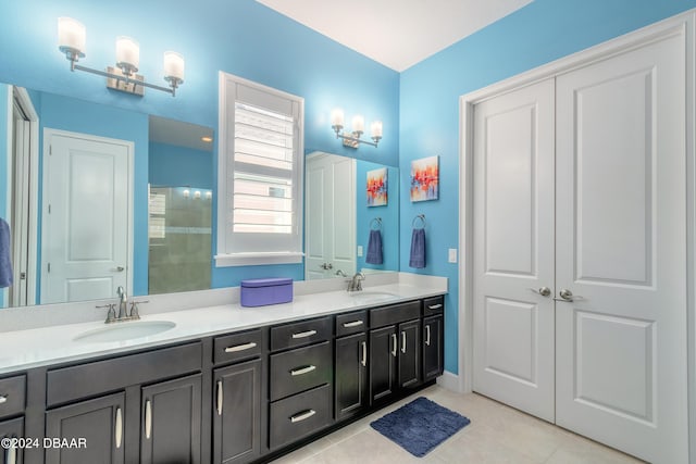 bathroom with walk in shower, vanity, and tile patterned floors