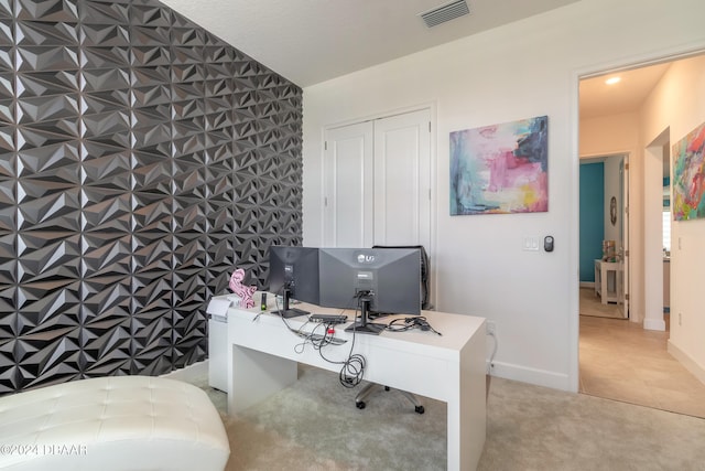 home office with a textured ceiling and light colored carpet