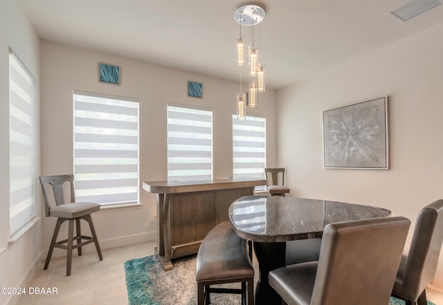 dining area with light tile patterned flooring