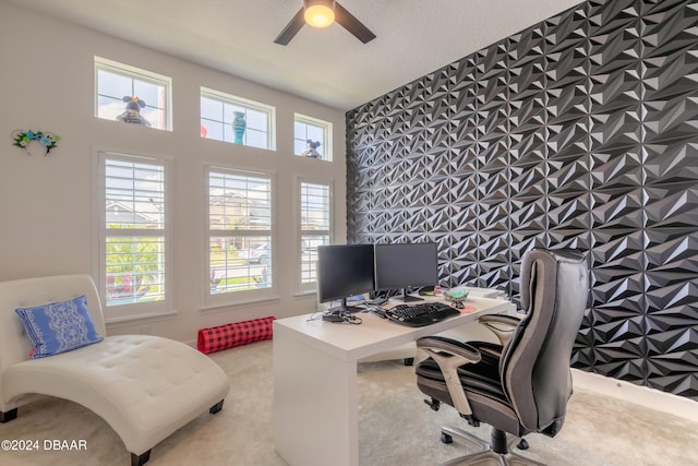 carpeted office featuring a textured ceiling and ceiling fan