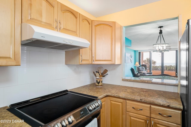 kitchen with stainless steel refrigerator, light brown cabinets, decorative backsplash, black range with electric stovetop, and a chandelier