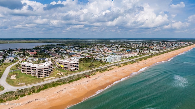 drone / aerial view featuring a water view and a beach view