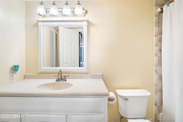 bathroom featuring vanity, toilet, and a shower with curtain