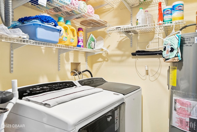 washroom with water heater and washer and clothes dryer