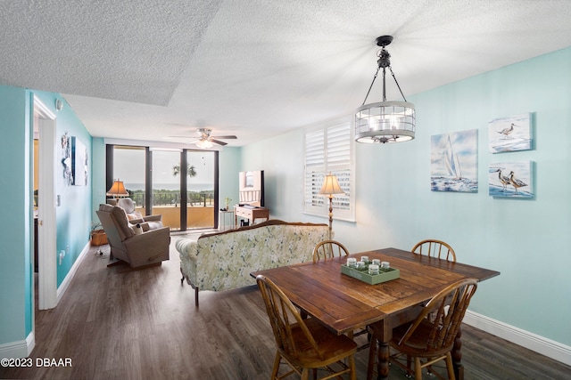 dining area featuring a textured ceiling, dark hardwood / wood-style floors, and ceiling fan with notable chandelier