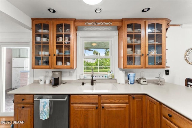 2667 John Anderson Dr, Ormond Beach, FL 32176 - kitchen featuring dishwasher, glass insert cabinets, light countertops, and brown cabinets