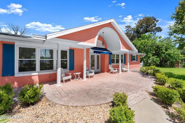 2667 John Anderson Dr, Ormond Beach, FL 32176 - rear view of house with a patio area and stucco siding