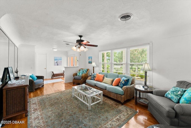 2667 John Anderson Dr, Ormond Beach, FL 32176 - living room featuring a textured ceiling, wood finished floors, and ceiling fan