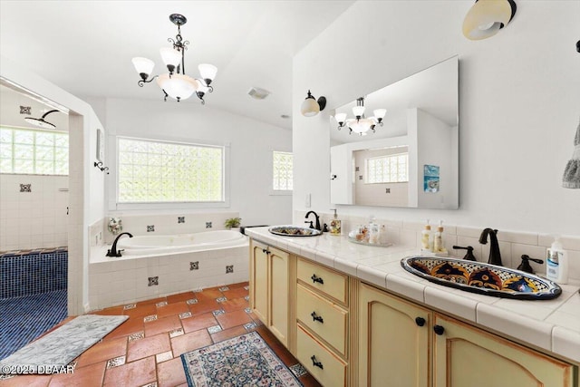 2667 John Anderson Dr, Ormond Beach, FL 32176 - full bathroom with a chandelier, a garden tub, double vanity, a tile shower, and lofted ceiling