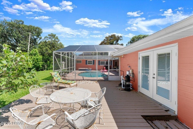2667 John Anderson Dr, Ormond Beach, FL 32176 - wooden deck with french doors, an outdoor pool, outdoor dining area, a lanai, and a patio area