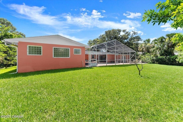 2667 John Anderson Dr, Ormond Beach, FL 32176 - back of property with a yard and a lanai