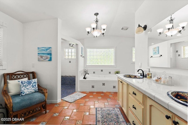 2667 John Anderson Dr, Ormond Beach, FL 32176 - full bath featuring a chandelier, plenty of natural light, a garden tub, and lofted ceiling