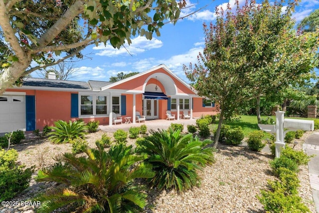 2667 John Anderson Dr, Ormond Beach, FL 32176 - single story home featuring french doors, stucco siding, and an attached garage