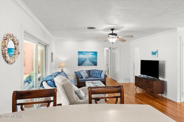 2667 John Anderson Dr, Ormond Beach, FL 32176 - living area featuring wood finished floors, ornamental molding, a ceiling fan, and a textured ceiling