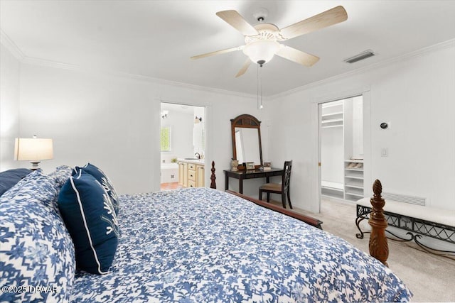 2667 John Anderson Dr, Ormond Beach, FL 32176 - carpeted bedroom with ornamental molding, a walk in closet, ceiling fan, and connected bathroom