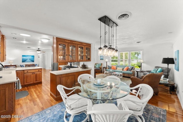 2667 John Anderson Dr, Ormond Beach, FL 32176 - dining room featuring light wood finished floors and a ceiling fan