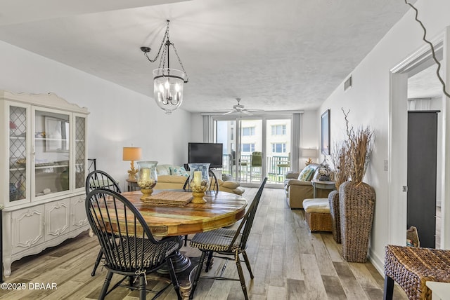 4555 S Atlantic Ave Unit 4209, Ponce Inlet, FL 32127 - dining space with a ceiling fan and light wood-style floors