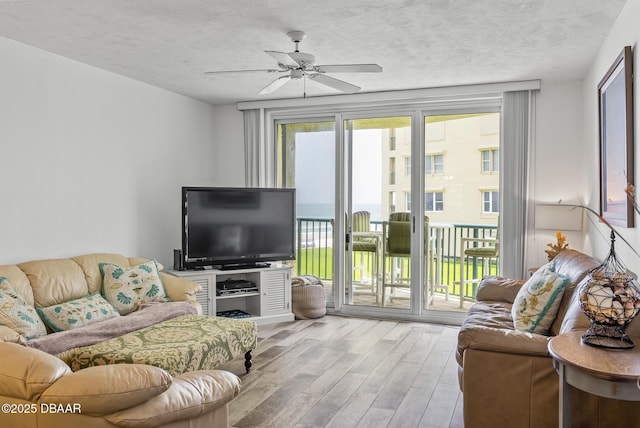 4555 S Atlantic Ave Unit 4209, Ponce Inlet, FL 32127 - living room featuring wood finished floors, ceiling fan, and a textured ceiling
