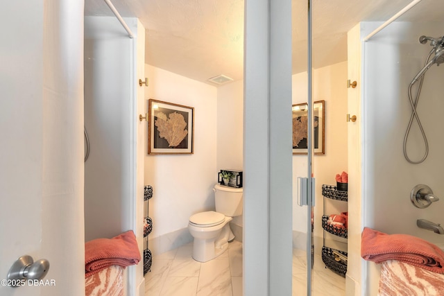 bathroom featuring visible vents, a shower stall, and toilet