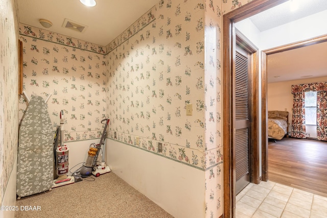 misc room featuring wallpapered walls and light tile patterned flooring