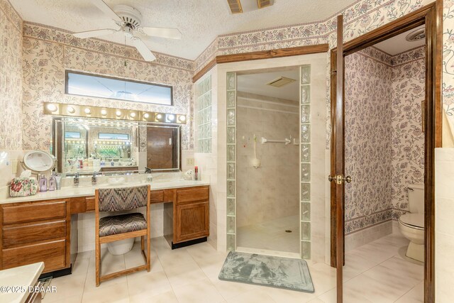 1680 Old Tomoka Rd Unit W, Ormond Beach, FL 32174 - bathroom with wallpapered walls, toilet, tile patterned flooring, vanity, and a tile shower