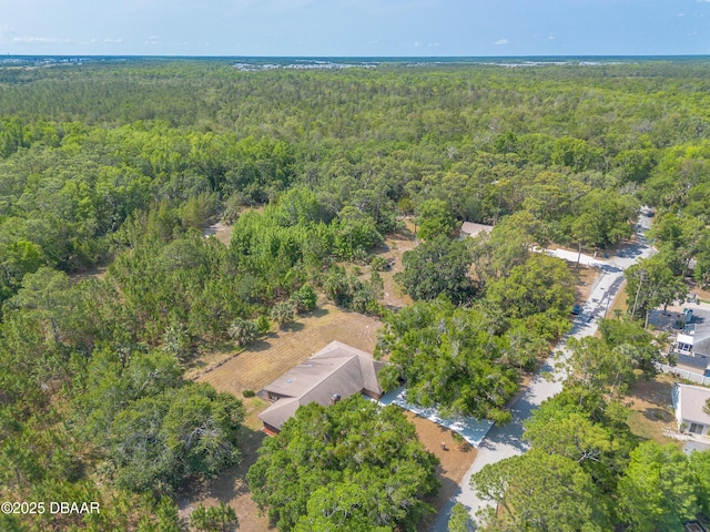 aerial overview of property's location with a heavily wooded area
