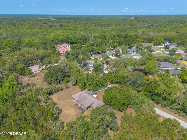 view of property location with a heavily wooded area