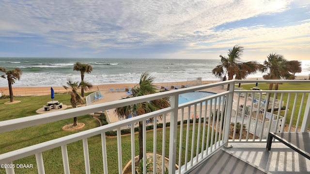 balcony featuring a water view and a view of the beach