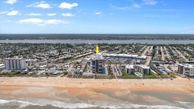 birds eye view of property featuring a beach view and a water view