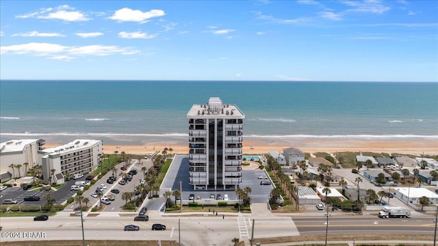 birds eye view of property featuring a beach view and a water view