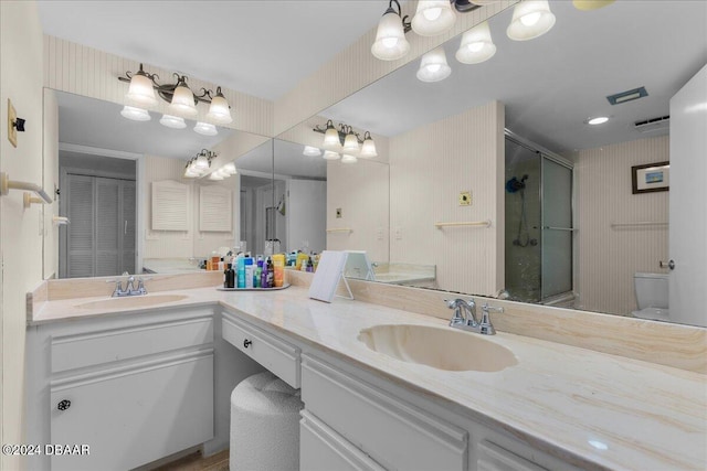 bathroom featuring walk in shower, vanity, and toilet