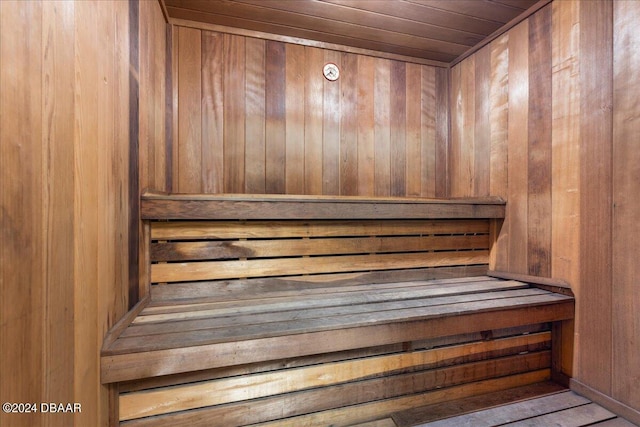 view of sauna / steam room with wooden walls and wooden ceiling