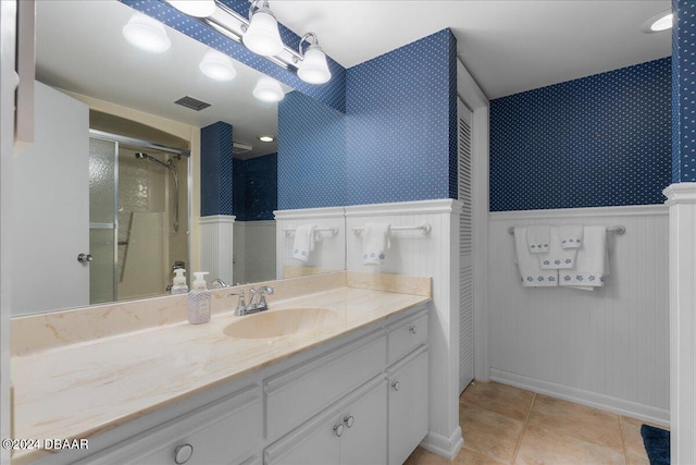 bathroom featuring vanity, tile patterned floors, and a shower with shower door