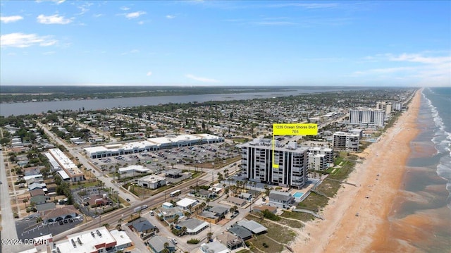 birds eye view of property featuring a view of the beach and a water view