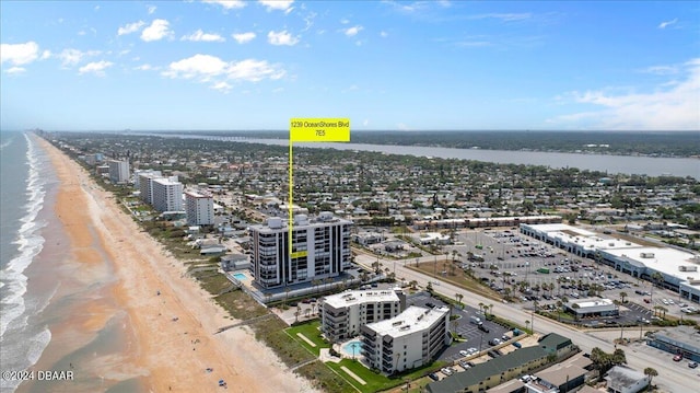 birds eye view of property with a view of the beach and a water view