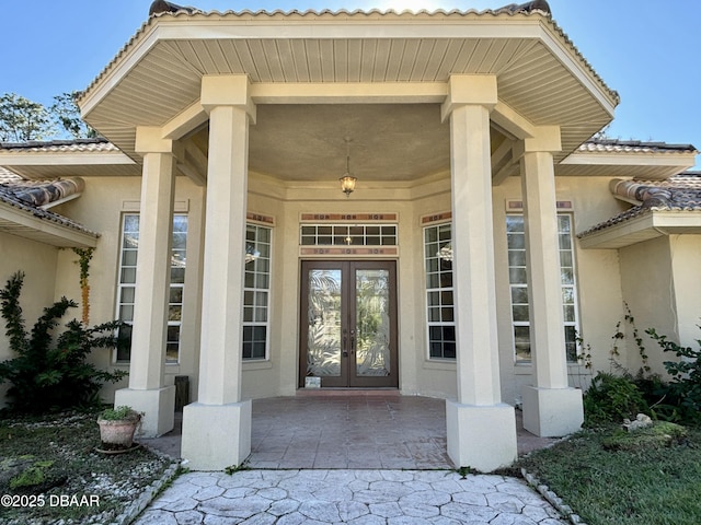 view of exterior entry featuring french doors