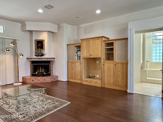 living room featuring a fireplace, dark hardwood / wood-style floors, and ornamental molding