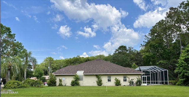 47 Elder Dr, Palm Coast, FL 32164 - view of side of home featuring a lawn, stucco siding, and glass enclosure
