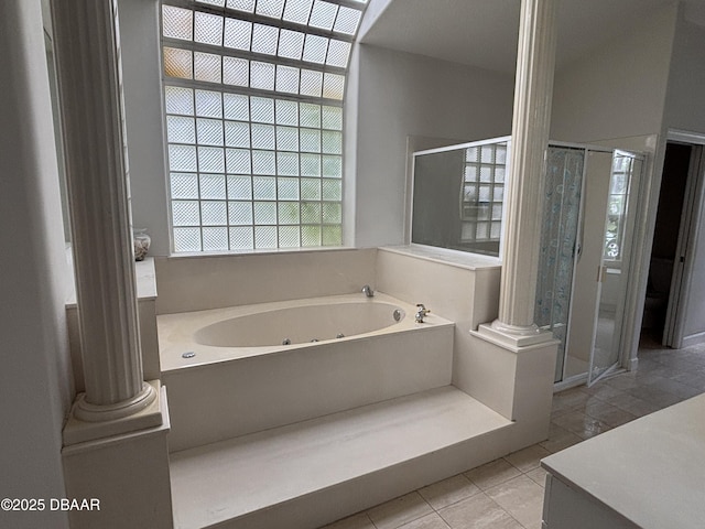 47 Elder Dr, Palm Coast, FL 32164 - full bathroom featuring ornate columns, a jetted tub, a shower stall, and tile patterned floors